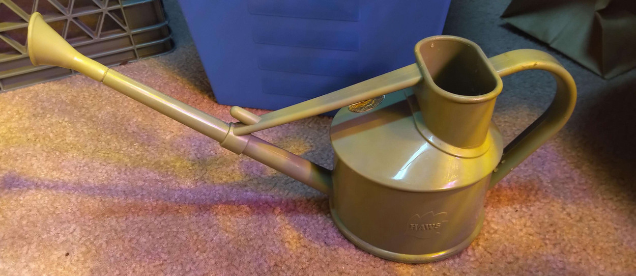 A green watering can.