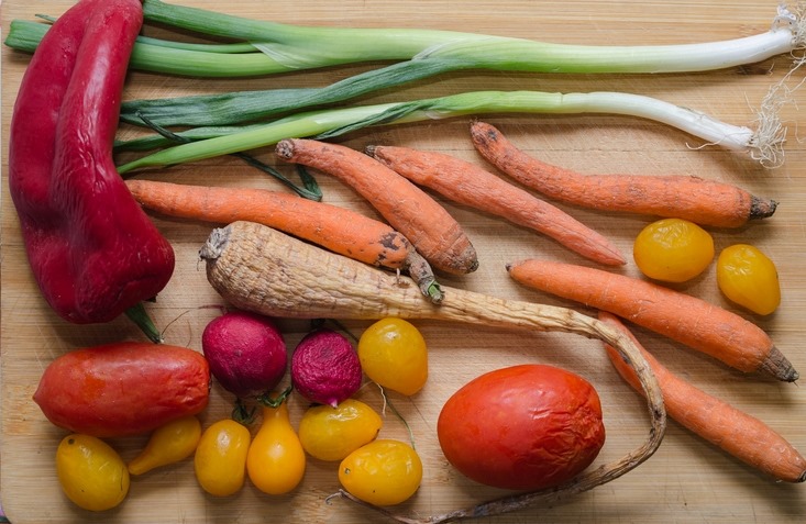 Fruits and vegetables on a table. They're wilting and a little old, but still edible