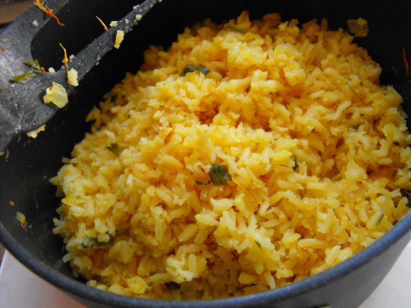 Orange coloured Mexican rice in a bowl.