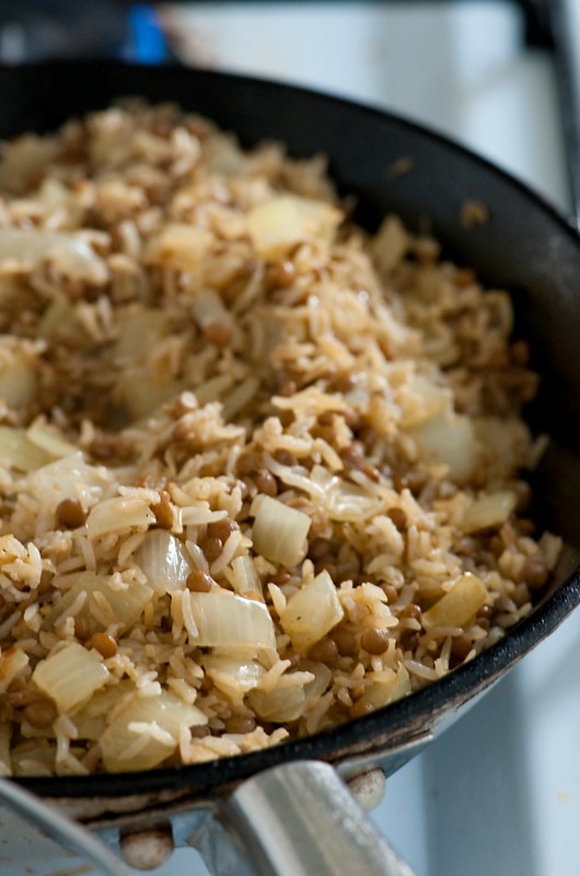 A pan filled with mujarara, a rice and lentil dish.