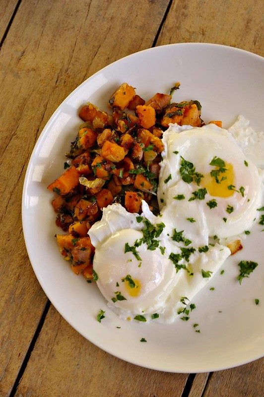 A plate of sweet potato hash with poached eggs.