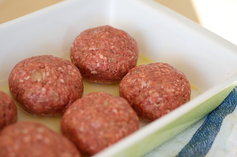 Raw meatballs in a baking dish.