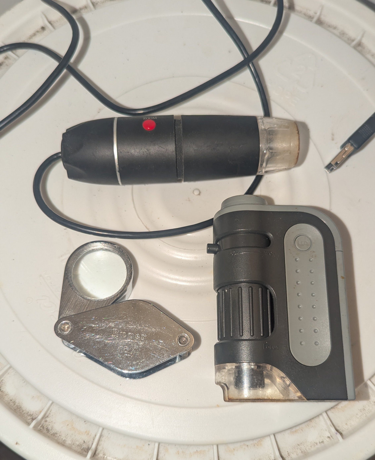 Various types of magnefying glasses and handheld microscopes