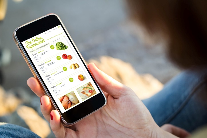 A person shopping for groceries on a smartphone.